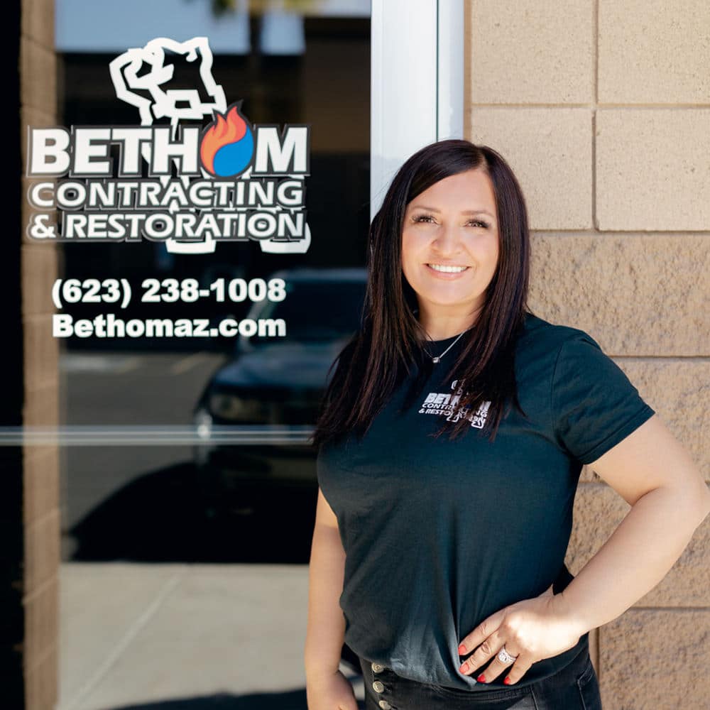 Alina standing in front of Bethom Contracting building